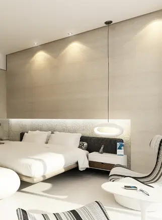 Photorealistic 3D interior rendering of a luxury hotel room, showcasing a modern bed, unique lounge chair, and sophisticated lighting.